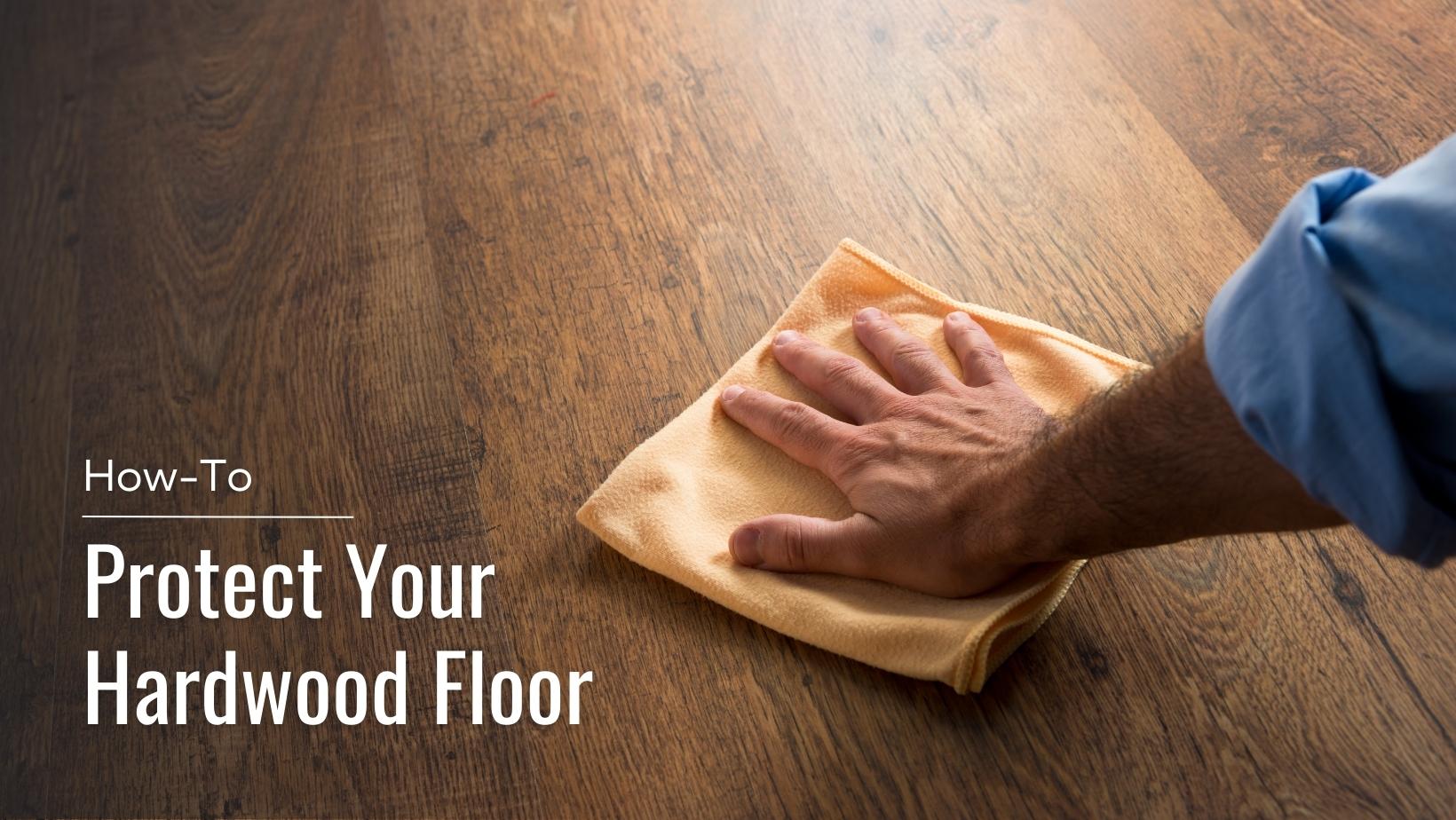 A man wiping the hardwood floor with a cloth